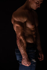 Obraz na płótnie Canvas Muscled male model flexing triceps