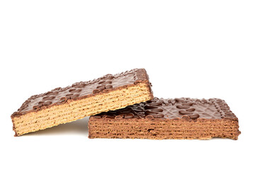 Two pieces of chocolate waffle cake lying on top of each other and isolated on white background