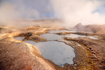 Steam pool in Sol de Manana at sunrise. Geyser field, Bolivia, South America