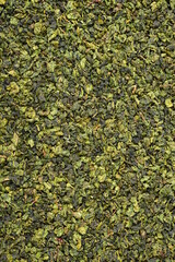 Dry green oolong tea leaves texture background