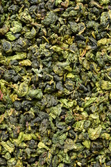 Fototapeta na wymiar Dry green oolong tea leaves texture background