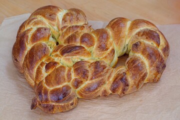 A braided challah brioche bread shaped as a heart