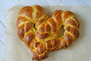 A braided challah brioche bread shaped as a heart