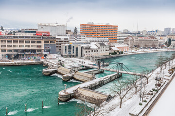 Obraz premium GENEVA, SWITZERLAND - February 13, 2021: Opened waterlocks on the Rhone after snow blizzard, Geneva, Switzerland.