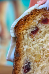 Traditional Easter bread or cake, decorated with white icing. Pannetone with raisins in section close-up. Easter food concept. High quality photo