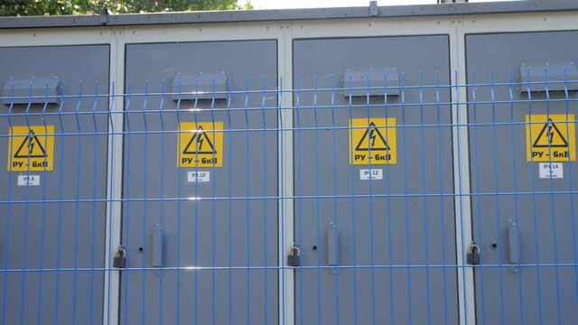 Lines of switch-board cabinets on electrical substation site