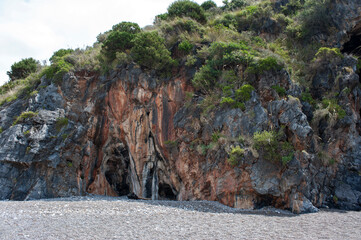 The typical cavernous rocks and maquis along the Cilento coast. Salerno, Italy, Europe.