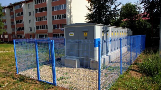 Electrical power substation at apartment building in summer