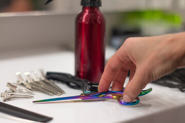 barber's hand takes scissors