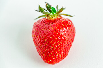 One bright strawberry on a white background, appetizing, beautiful, dietary. Place for text, copy space, flat lay