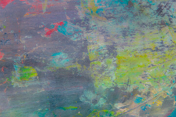 colorful creative motley background: smudged residues of oil paints on a wooden palette, short...