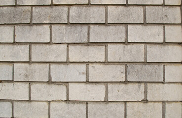 The texture is made in the form of a wall made of old light brick.
