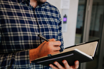 Man writing his plans into his diary. Business concept.
