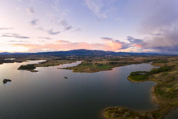 Lake drone aerial view of mountain panorama landscape at sunset in Marateca Dam in Castelo Branco, Portugal