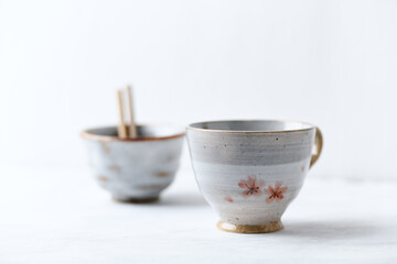 Traditional, handcrafted ceramic on bright wooden background. Copy space.	