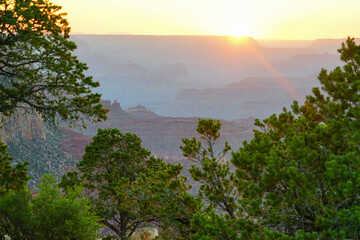 Golden Sunset at Grand Canyon Arizona. Blue smoky haze accentuates the canyon