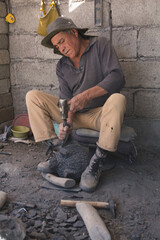 Craftsman, stone laborer creating molcajetes, a traditional Mexican kitchen utensil to grind spices such as chili, avocado, pepper, garlic. 