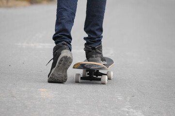 young man practicing sport with a skateboard in the street