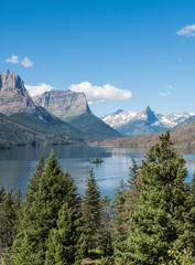 Scenic of the Canadian Rockies with mountains, a lake and evergreen trees.
