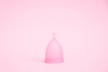 Menstrual cup on pink background. Alternative feminine hygiene product during the period. Women...