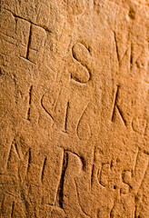 19th century graffitti on an old sandstone wall, UK