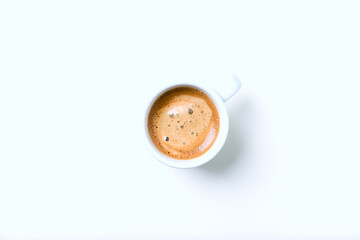 Cup of coffee on bright background. Top view.
