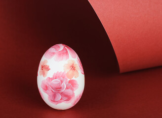 Easter Egg with pink floral pattern on red background