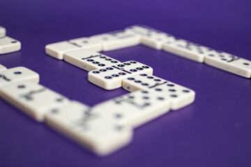 Old fashioned dirty domino stands on a solid backround
