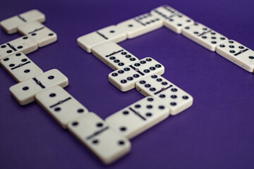 Old fashioned dirty domino stands on a solid backround

