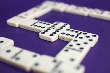 Old fashioned dirty domino stands on a solid backround
