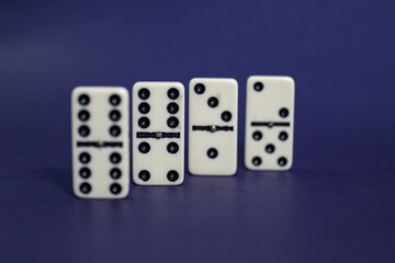 Old fashioned dirty domino stands on a solid backround
