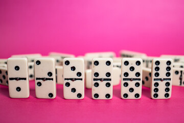 Old fashioned dirty domino on a box with pink solid backround
