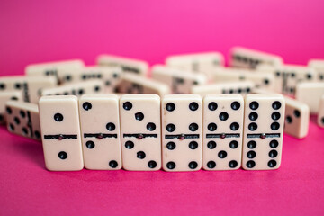 Old fashioned dirty domino on a box with pink solid backround
