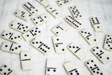 Old fashioned dirty domino stands on a solid background
