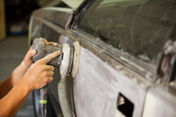 Bulgarian mechanic working in auto shop.