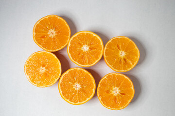 Slices of orange or tangerine isolated on white background. Flat lay, top view. Fruit composition