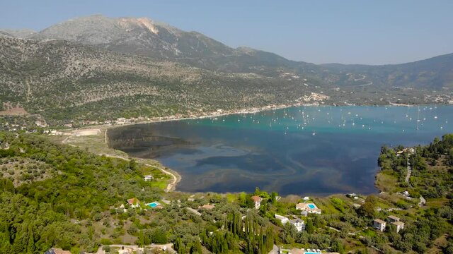 Desimi Beach Golf and nearby Island with clear water in Greece. Aerial