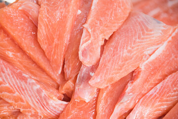 Preparing sushi with Raw salmon steak, rice and fresh avocados

