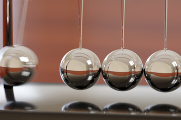 Close up of Newton's cradle swinging. 3d illustration.