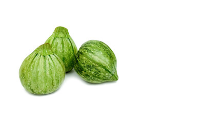 Green zucchini or courgette (Cucurbita pepo) isolated on white background with space for text