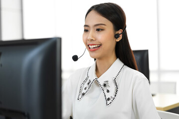 Beautiful happy call center smiling asian businesswoman operator customer support phone services agen working with headset and computer at call center