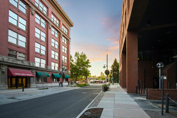 The old Spokane, Washington, USA City Hall building with Riverfront Park filled with booths and vendors at sunset during a festival in the downtown.