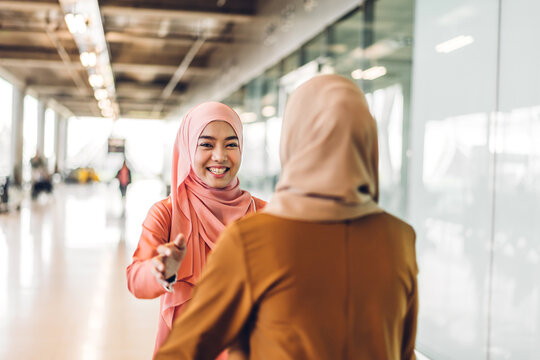 Portrait of happy arabic two friend muslim woman with hijab dress smiling and talking together at store