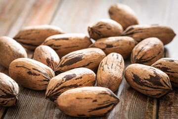 Pecan Nuts In Shell On Wood Table