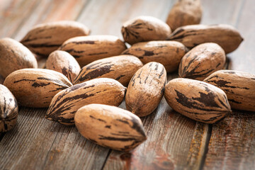 Pecan Nuts In Shell On Wood Table