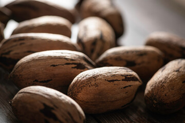 Pecan Nuts In Shell On Wood Table