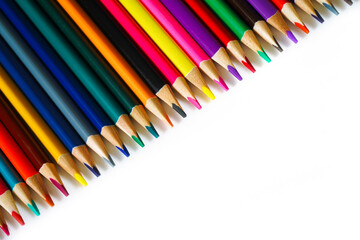 A lot of colored pencils on a white background. Colored watercolor in the form of pencils. Tools for the artist