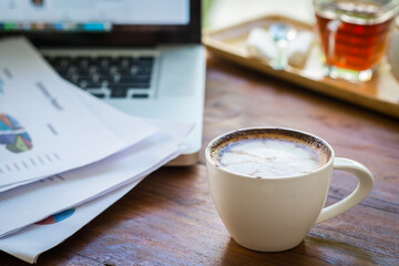 Coffee mugs on work desks and laptops