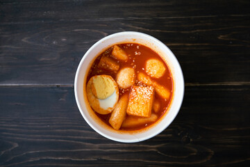 Stir-fried Rice Cake Tteok-bokki in a takeaway container. Korean food delivery.