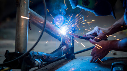 Welding of steel, sparking, not wearing gloves, light colored like fireworks.